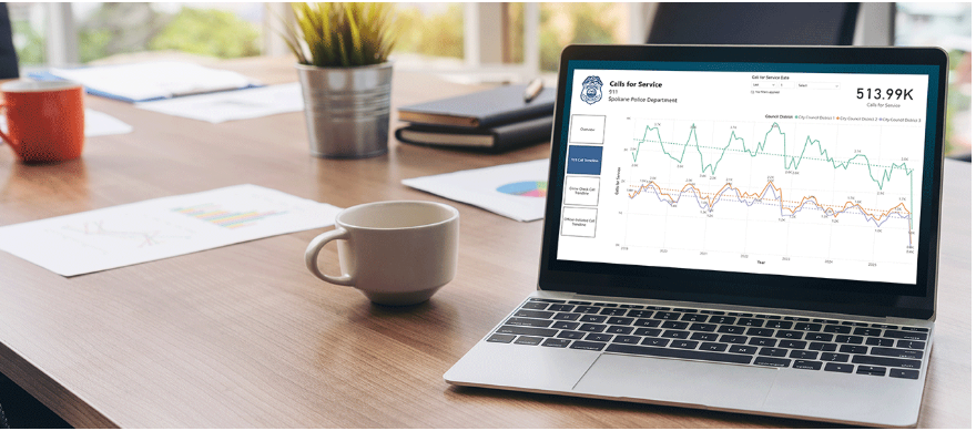 A laptop sitting on a table with a graph of crime rates on the screen.